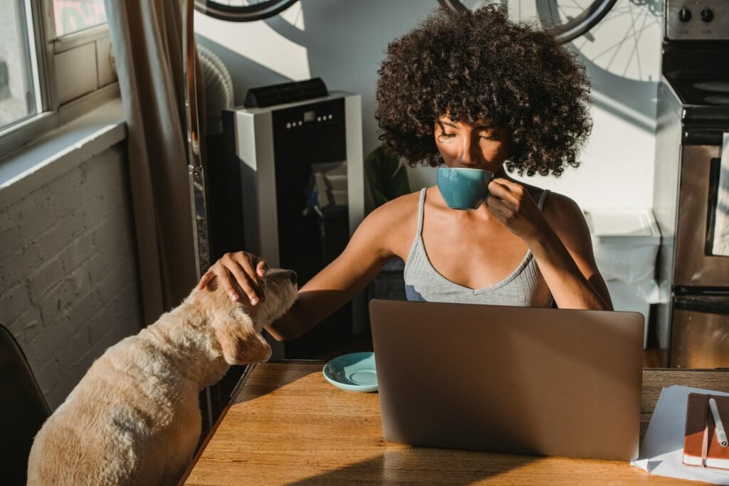 Woman creating digital content on a laptop in her home content studio